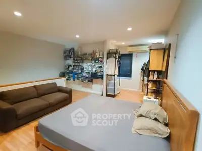 Spacious bedroom with cozy seating and organized storage