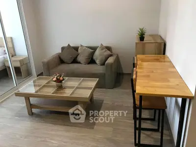 Cozy living room with modern furniture and wooden accents in a stylish apartment.