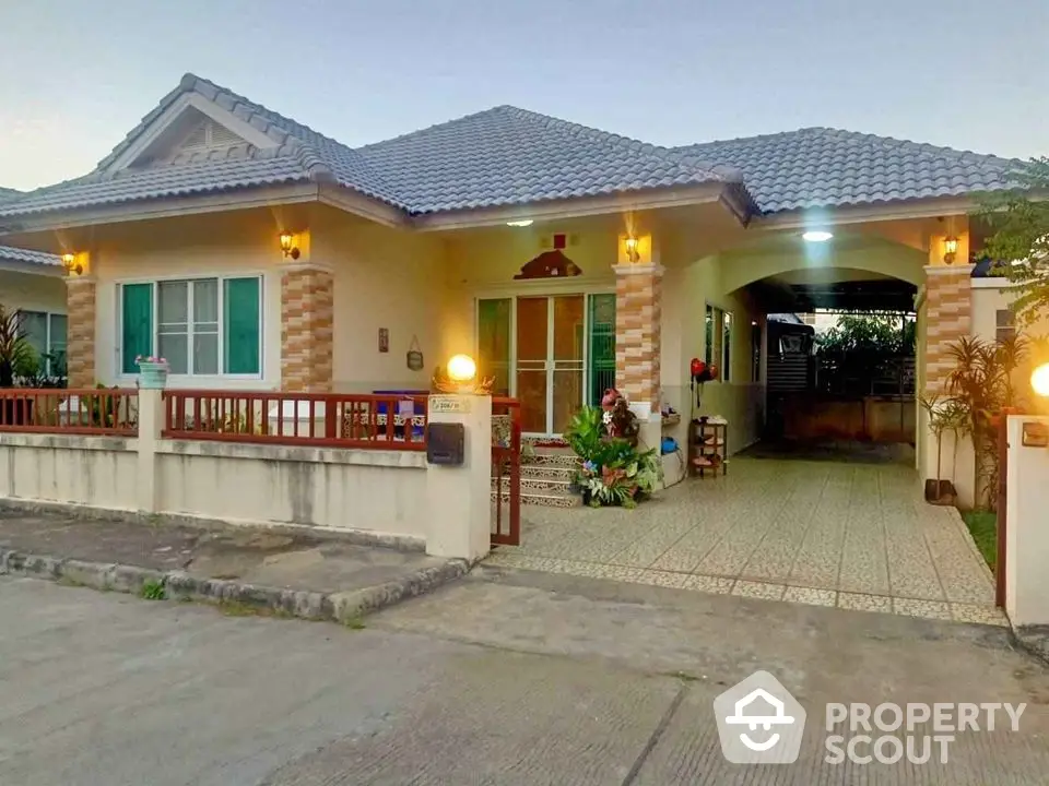 Charming single-story house with tiled roof and inviting entrance, perfect for family living.