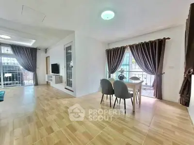 Spacious living room with elegant dining area and large windows