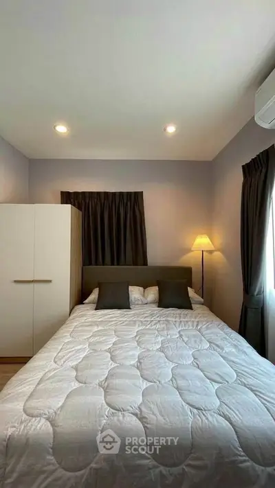 Cozy bedroom with modern decor and soft lighting, perfect for relaxation.