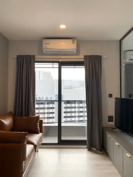 Modern living room with balcony view and stylish furniture