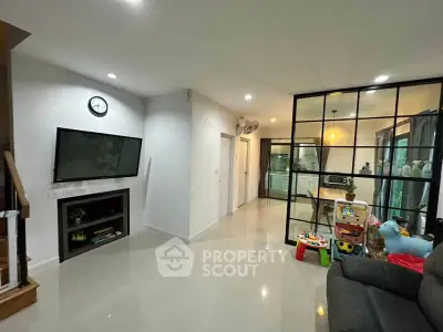 Modern living room with open layout and stylish glass partition