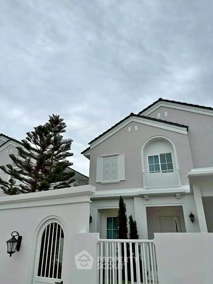 Elegant two-story house with classic architecture and lush greenery, perfect for modern family living.