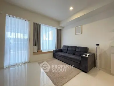 Spacious living room with modern sofa and natural light