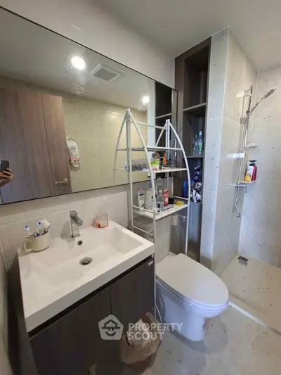 Modern bathroom with sleek fixtures and spacious shower area