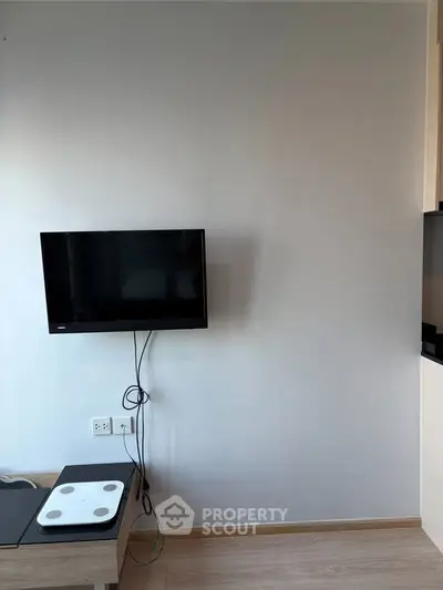 Modern living room with wall-mounted TV and minimalist decor