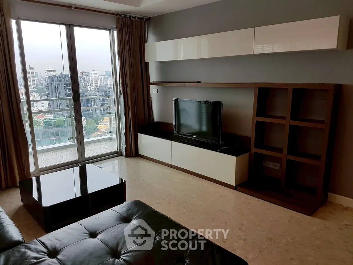 Modern living room with city view, sleek furniture, and large windows in a high-rise apartment.