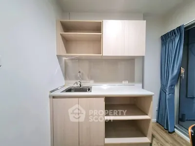 Modern compact kitchen with sleek cabinetry and stainless steel sink