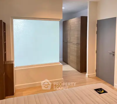 Modern bedroom with wooden flooring and built-in wardrobe