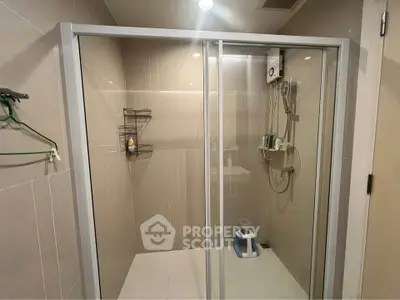 Modern bathroom with glass shower enclosure and sleek fixtures