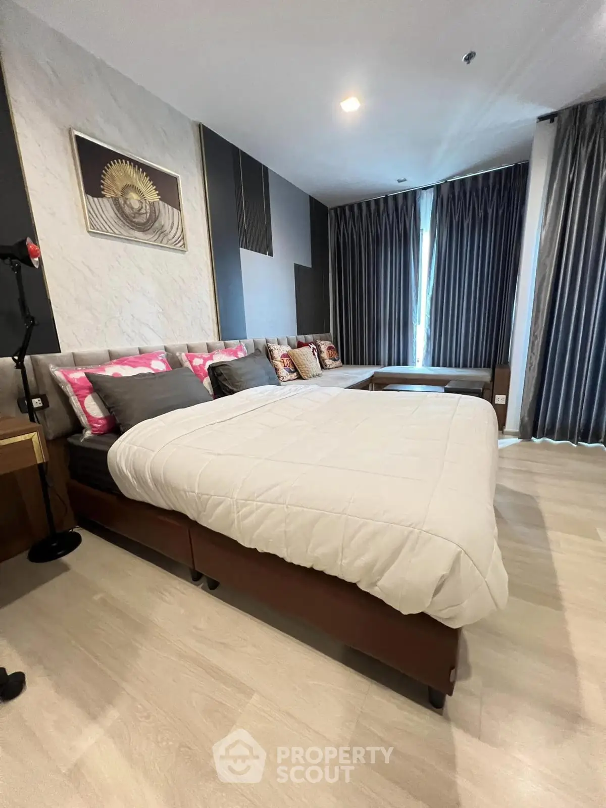 Spacious modern bedroom with elegant decor and natural light