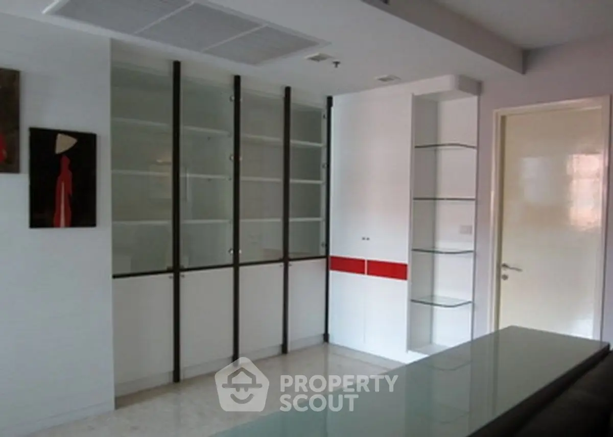 Modern living room with sleek built-in cabinets and minimalist decor.