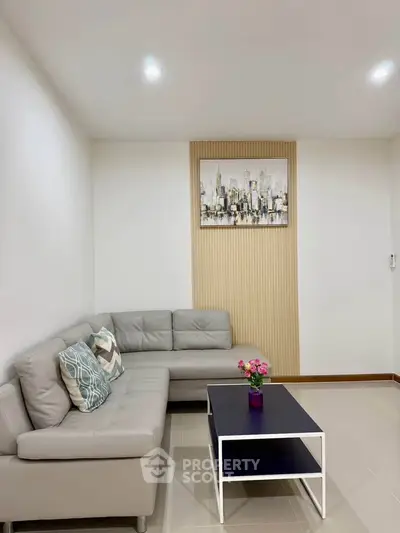 Modern living room with stylish gray sofa and chic decor
