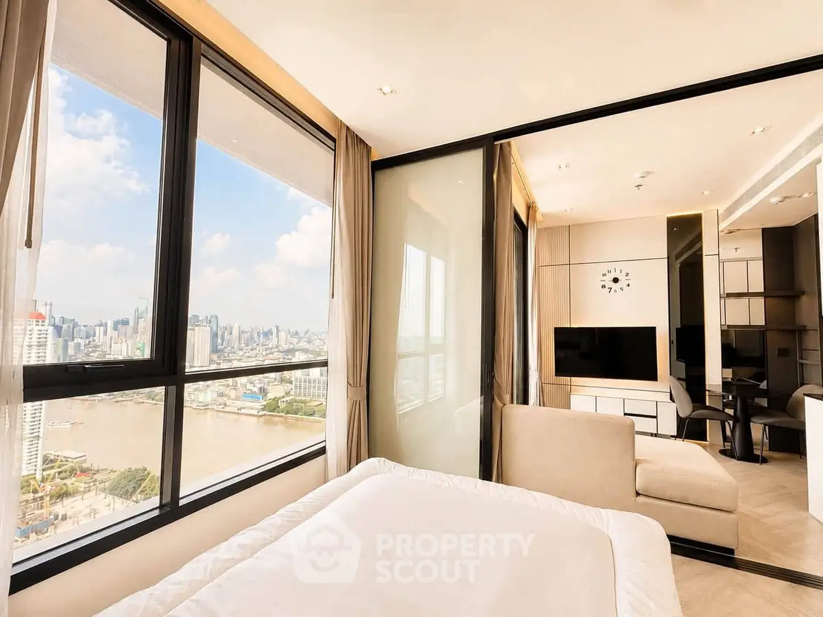 Luxurious high-rise apartment with stunning river and city views, featuring modern living room and bedroom.