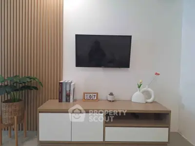 Modern living room with wall-mounted TV and stylish decor