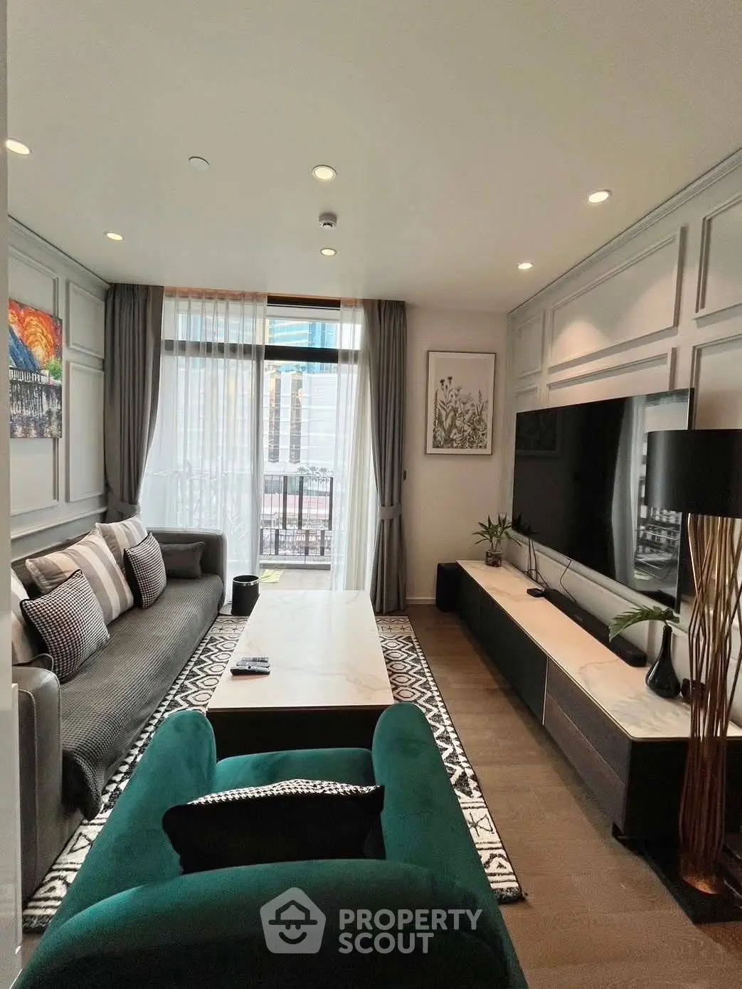 Luxurious living room with modern decor, large TV, and elegant furniture, perfect for relaxation and entertainment.