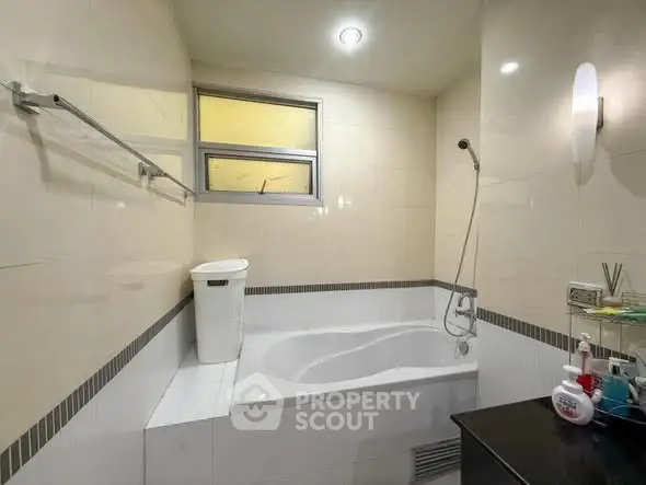Modern bathroom with bathtub and sleek lighting, perfect for relaxation.