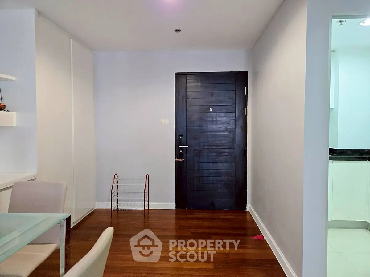 Modern apartment entrance with wooden flooring and sleek design