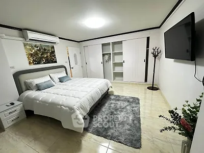 Spacious modern bedroom with elegant decor and ample storage space