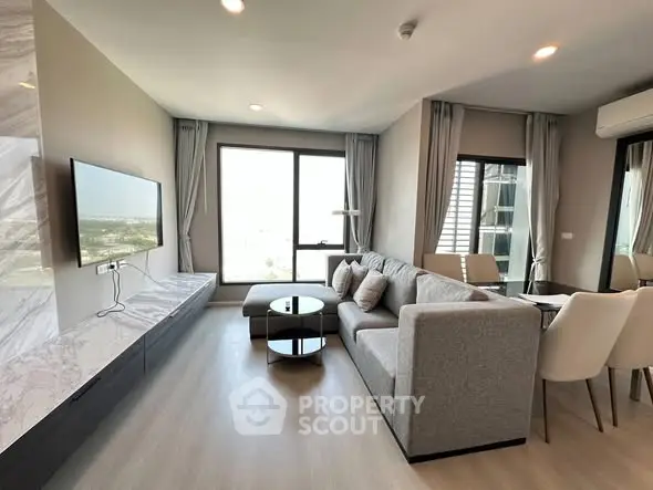 Modern living room with sleek furniture and large windows offering a stunning view.