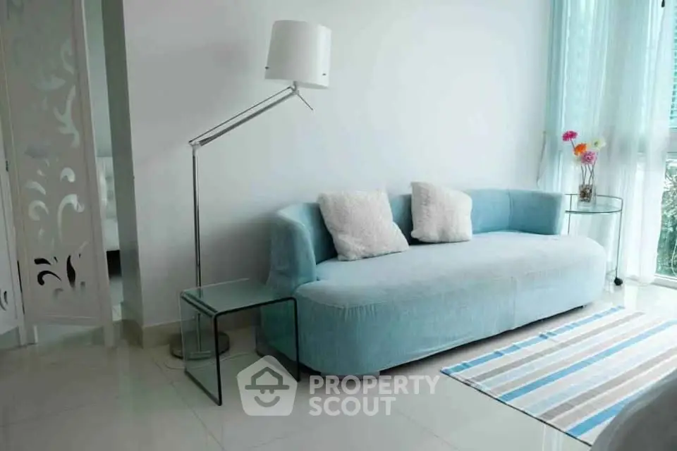 Modern living room with stylish blue sofa and elegant floor lamp