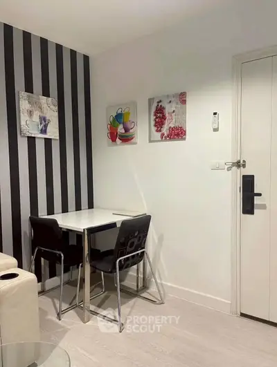 Chic modern dining nook with stylish black and white decor, perfect for cozy meals.