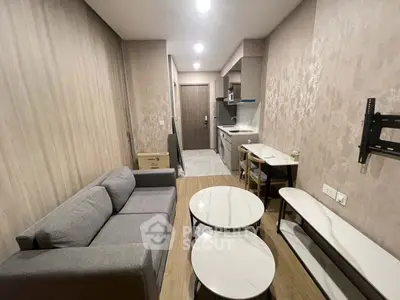 Modern compact living room with open kitchen layout and stylish furniture