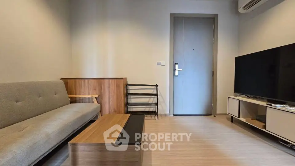 Modern living room with sleek furniture and flat-screen TV