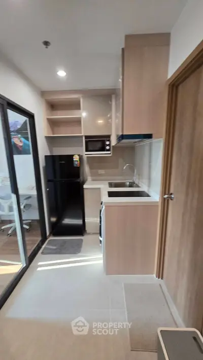 Modern compact kitchen with sleek appliances and open layout design