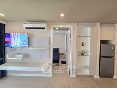 Modern living room with sleek design, built-in shelves, and air conditioning unit.