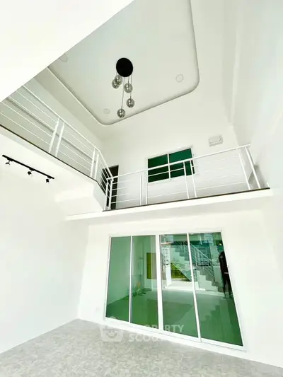 Stunning modern interior with high ceilings and mezzanine in a bright living space.