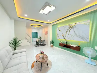 Modern living room with stylish decor and open layout, featuring elegant lighting and contemporary furniture.