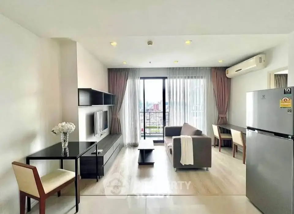 Modern living room with balcony view, sleek furniture, and natural light in a stylish apartment.