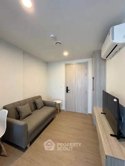 Modern living room with sleek furniture and air conditioning in a cozy apartment.