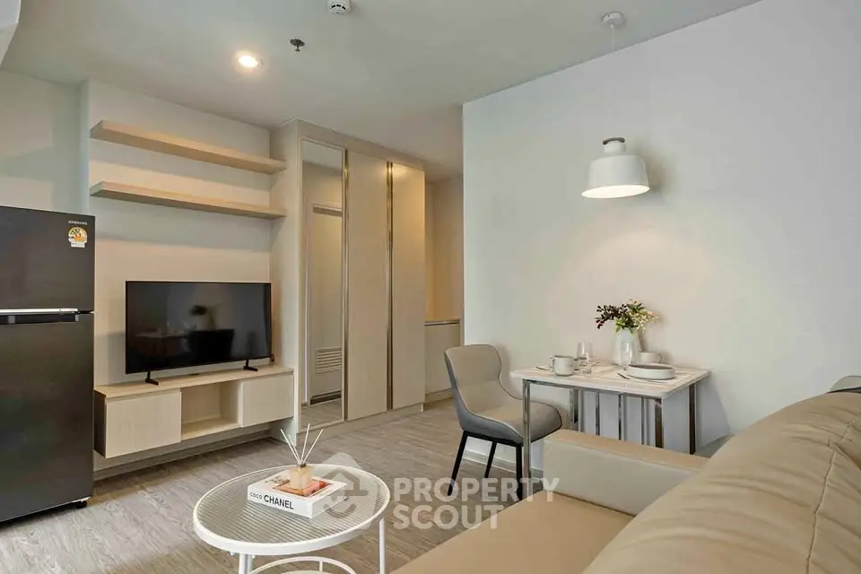 Modern living room with sleek furniture and cozy dining area in a stylish apartment.