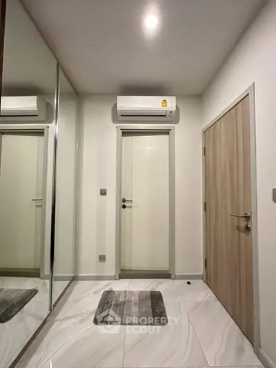 Modern hallway with sleek air conditioning and elegant tile flooring