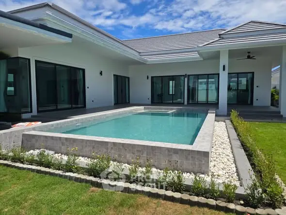Luxurious modern home with private pool and lush garden, perfect for relaxation and entertainment.