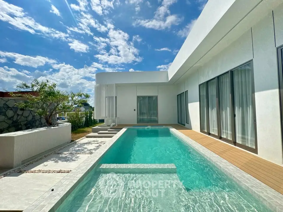 Luxurious modern villa with private pool and stunning architectural design under a clear blue sky.