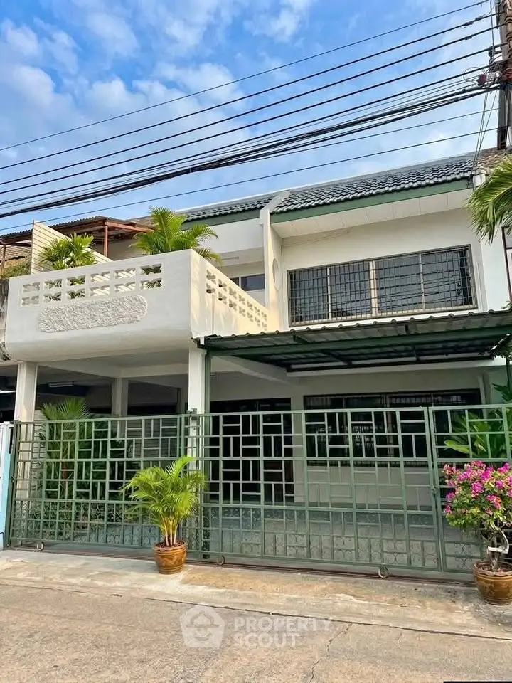 Charming two-story house with modern facade and lush greenery, perfect for family living in a serene neighborhood.