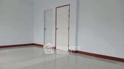 Spacious empty room with white walls and tiled floor, ready for customization.