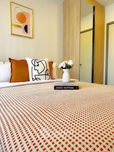 Stylish bedroom with modern decor and cozy bedding in a chic apartment.
