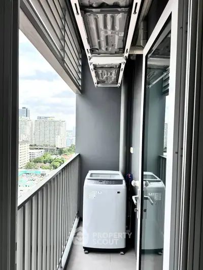 Modern balcony with washing machine and city view in high-rise apartment