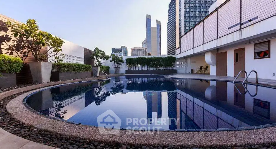 Luxurious rooftop pool with stunning city skyline views, perfect for relaxation and leisure.