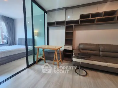 Modern living room with glass partition and cozy bedroom view