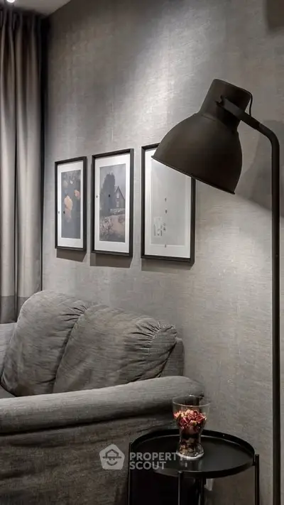 Cozy living room with stylish decor and framed art on wall.