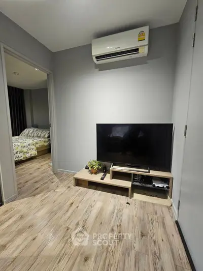 Cozy living room with modern TV setup and wooden flooring