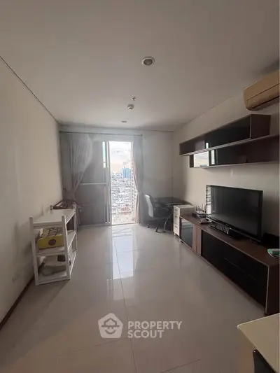 Spacious living room with city view, modern furniture, and natural light.