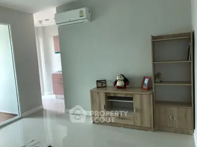 Modern living room with sleek furniture and air conditioning in a bright, minimalist apartment.