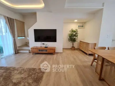 Spacious modern living room with wooden flooring and stylish furniture